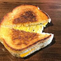 The Classic · Melted cheese inside bread butter-toasted on the griddle.