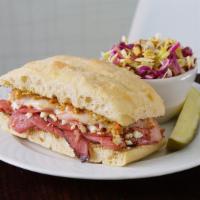 Muffuletta · Thinly sliced pastrami, salami & ham topped with our muffuletta olive spread, provolone & fe...