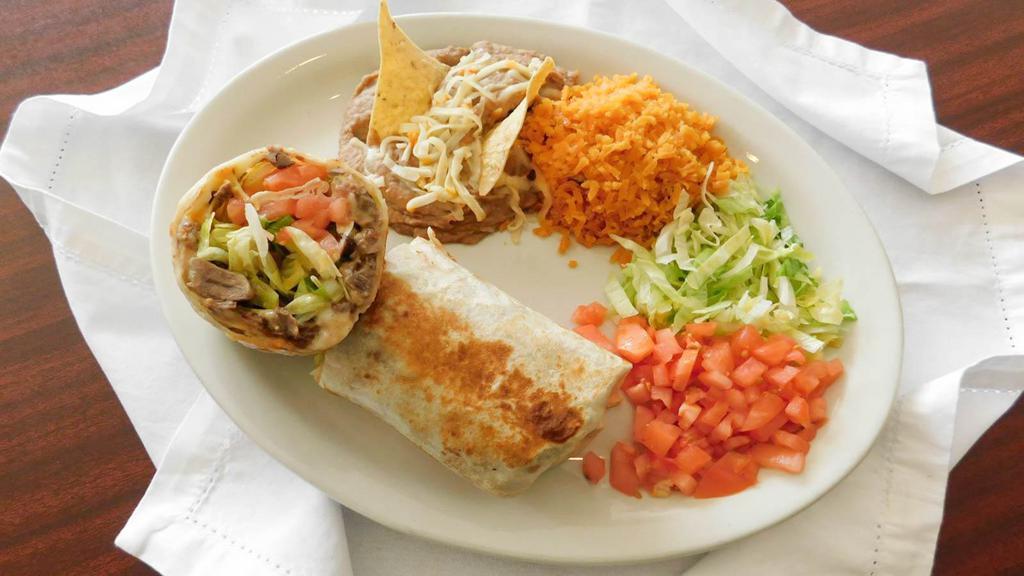 Chimichanga Burrito Dinner · Deep fried flour tortilla with cheese, lettuce, tomatoes and your choice meat. Includes rice and beans.