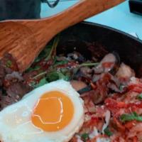 Huevos Con Bistek Or Carne Asada · Three eggs with steak.