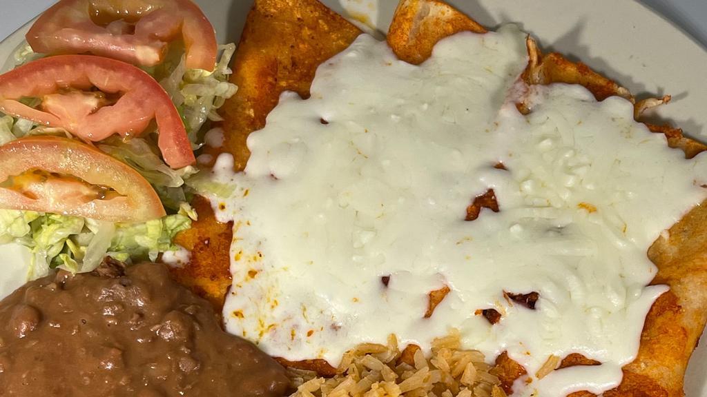 Enchiladas De Queso / Cheese Enchiladas · Four cheese enchiladas with red or green sauce, served with rice, beans, lettuce and tomatoes. And meat (chicken or beef) for $2.00