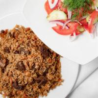 Pilav · Traditional central Asian meal prepared with beef, ground rice, carrots, onions, garbanzo pe...