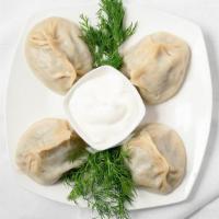 Manti (Traditional Dumplings) · Manti dumplings consist of a spiced and diced beef meat in a dough wrapper and steamed. Serv...