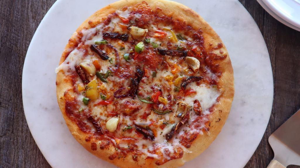 Mediterraneo · Sun-dried tomatoes, roasted garlic, tri colored peppers, roasted peppers, marinara sauce and mozzarella.