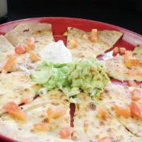 Quesadilla · Soft flour tortillas stuffed with melted cheese, onions and tomatoes. Served with sour cream...