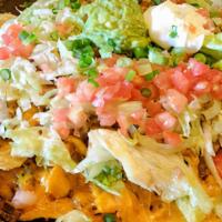 Nachos Supreme · Crisp tortilla chips loaded with chicken, ground beef, shredded beef, beans and cheese dip s...
