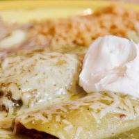 Enchiladas Suizas · Two corn tortillas stuffed with your choice of filling with a delicious green tomatillo sauc...