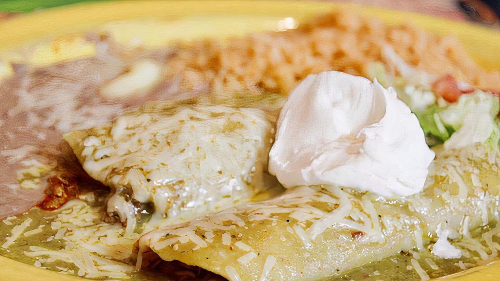 Enchiladas Suizas · Two corn tortillas stuffed with your choice of filling with a delicious green tomatillo sauce and melted cheese.