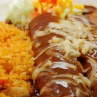 Mole Enchiladas · Two corn tortillas stuffed with tender shredded chicken. Topped with delicious sweet spicy m...