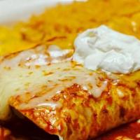 Enchiladas Colorado · Two corn tortillas filled with chunks of beef. Topped with tasty Colorado sauce and melted c...
