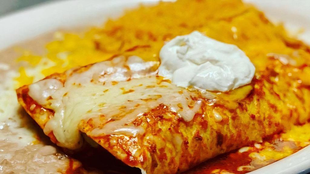 Enchiladas Colorado · Two corn tortillas filled with chunks of beef. Topped with tasty Colorado sauce and melted cheese.