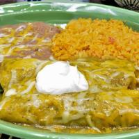 Enchiladas Verdes · Two corn tortillas filled with chunks of pork. Topped with tomatillo green sauce and melted ...