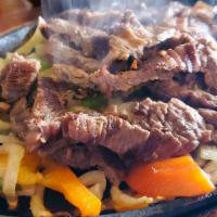 Steak Fajita · A sizzling grilled dish with sauteed onions and green peppers. served with rice beans guacam...