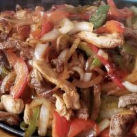Trio Fajita · A sizzling grilled dish with sauteed onions and green peppers. served with rice beans guacam...