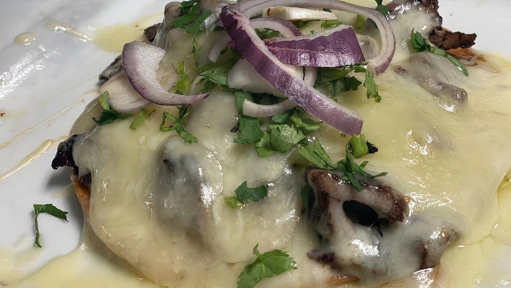 Volcan · Crispy Corn Tortilla with your choice of Carne asada, al Pastor, or Grill chicken, melted  Monterrey Cheese and home-made tomatillo sauce. Topped with cilantro and red onion.