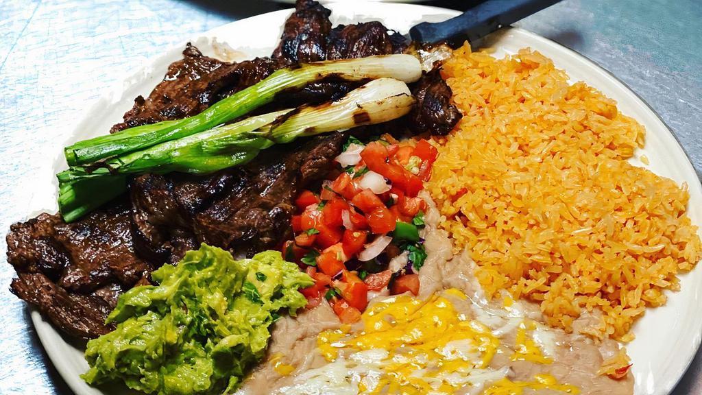 Carne Asada · Charcoal grilled skirt steak served with guacamole and pico de gallo.