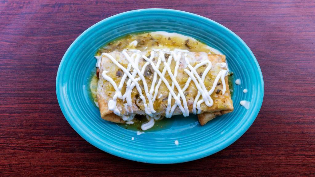 King'S Chimichanga · A large tortilla filled with your choice of ground beef, shredded beef or shredded chicken covered with cheese sauce, red sauce, and topped with lettuce, guacamole, sour cream, and tomatoes.