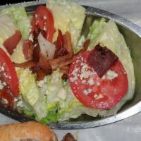 Wedge Salad · Iceberg wedge, applewood smoked bacon, red onion, tomato, chunky blue cheese dressing.