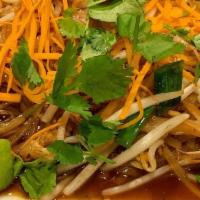 Pad Thai · Rice noodle stir fry with carrots, cilantro, green onions, eggs, and bean sprouts.