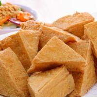 Deep Fried Tofu · Deep fried bean curd cakes, complement with sweet and sour sauce topped with crush peanut.