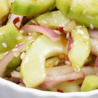 Cucumber Salad · Crispy fresh cucumber with sweet and sour dressing topped with onion.