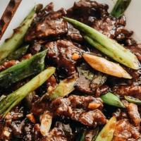 Mongolian Beef · Stir fried beef with onions, green onion and brown sauce. Served with white jasmine rice.