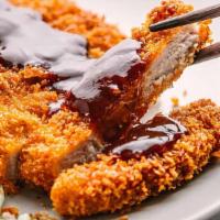 Tonkatsu Pork · Deep fried breaded pork chop on top of jasmine rice and tonkatsu sauce.