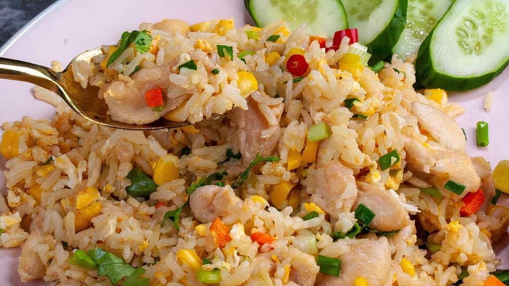 Thai Fried Rice · Stir fried rice with egg, carrot, onion and choice of meat topped with green onion.