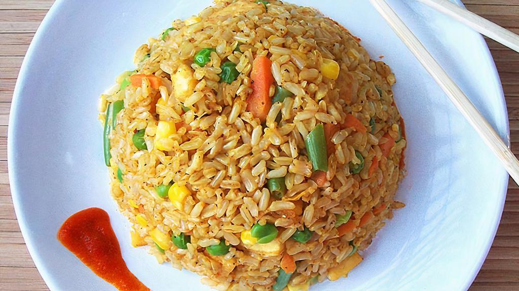Curry Fried Rice · Stir fried rice with egg, curry powder, onion carrot topped with green onion and your choice of meat.