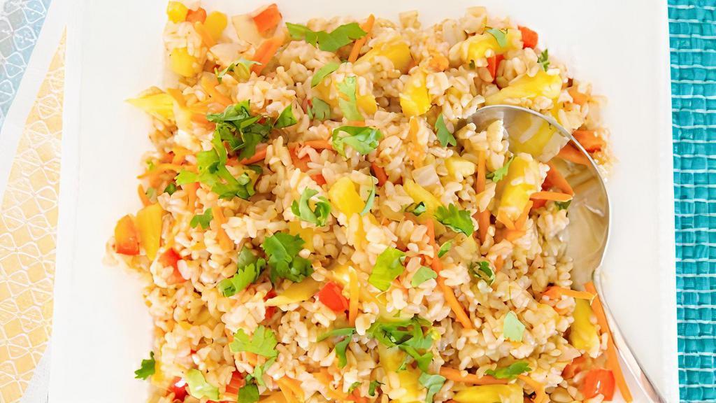 Pineapple Fried Rice · Stir fried rice with egg, onion, carrot, and pineapple with your choice of meat topped with green onion.