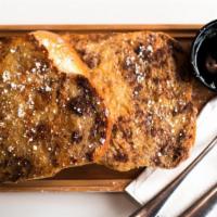 Challah French Toast · Two thick slices of Challah Bread grilled in an egg/cinnamon sugar batter.  Covered in Powde...