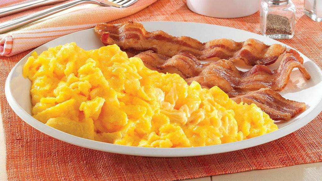 Two Egg Breakfast · Scrambled eggs served with your choice of bacon, sausage links, or sausage patties, and hashbrowns or grits..