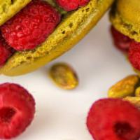 Pistachio Ispahan · Pistachio flavored macaron filled with pistachio cream, embellished with fresh raspberries.