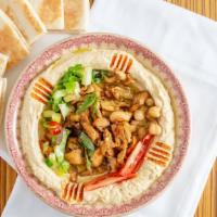 Shawarma Hummus · A base of hummus topped with chicken shawarma, onions, and tomato, served with pita.