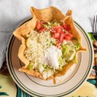Taco Salad · Flour tortilla bowl filled with beef or chicken, cheese, beans, lettuce, tomato and sour cre...