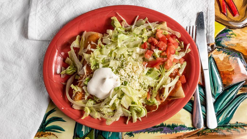 Enchiladas Supreme · Supreme combo of enchiladas - 1 chicken, 1 ground beef, 1 cheese and 1 shredded beef topped with red sauce, lettuce, sour cream and tomatoes.