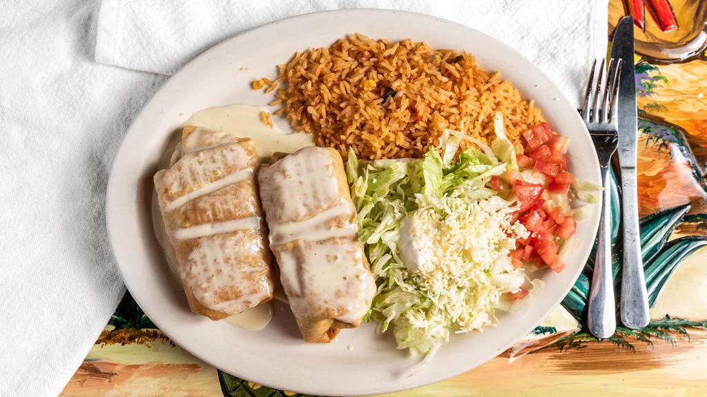 Seafood Chimichangas · 2 flour tortillas stuffed with shrimp, crab, scallops, onion, green peppers and tomato. Served with rice or beans.