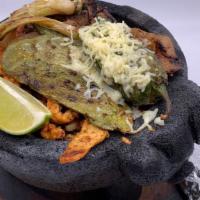 Cilantro Molcajete · Pork, steak, chicken, shrimp and chorizo grilled with mushrooms, squash, Mexican onions mari...