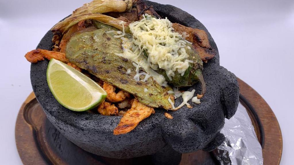 Cilantro Molcajete · Pork, steak, chicken, shrimp and chorizo grilled with mushrooms, squash, Mexican onions marinated in a green sauce and covered with melted cheese, accompanied with rice, beans, guacamole salad and tortillas.