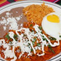 Huevos Con Chilaquiles · Tortilla chips simmered in spicy tomatillo or mild sauce with cheese, sour cream and onion.