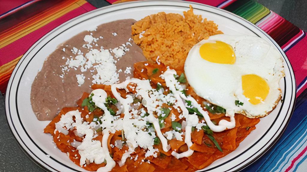 Huevos Con Chilaquiles · Tortilla chips simmered in spicy tomatillo or mild sauce with cheese, sour cream and onion.
