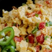 Huevos A La Mexicana · Scrambled eggs with jalapenos, onions, and tomato.