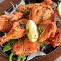 Tandoori Chicken · Chicken legs and thighs marinated in yogurt, spices and lemon juice roasted in a clay oven.