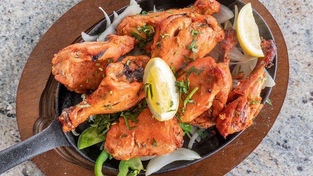 Tandoori Chicken · Chicken legs and thighs marinated in yogurt, spices and lemon juice roasted in a clay oven.