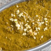 Palak Paneer · Soft cubes of homemade cheese simmered in creamy spinach with spices and herbs