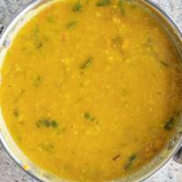 Daal Tadka · Yellow lentils cooked with fresh spices, onion, ginger, tomato, and cilantro