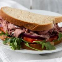 Roast Beef And Swiss · Thick slices of roast beef served with swiss cheese, tomato, onion and a house made horserad...