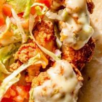 Crispy Chicken · Marinated chicken lightly breaded and fried to golden brown. Served over lettuce and topped ...