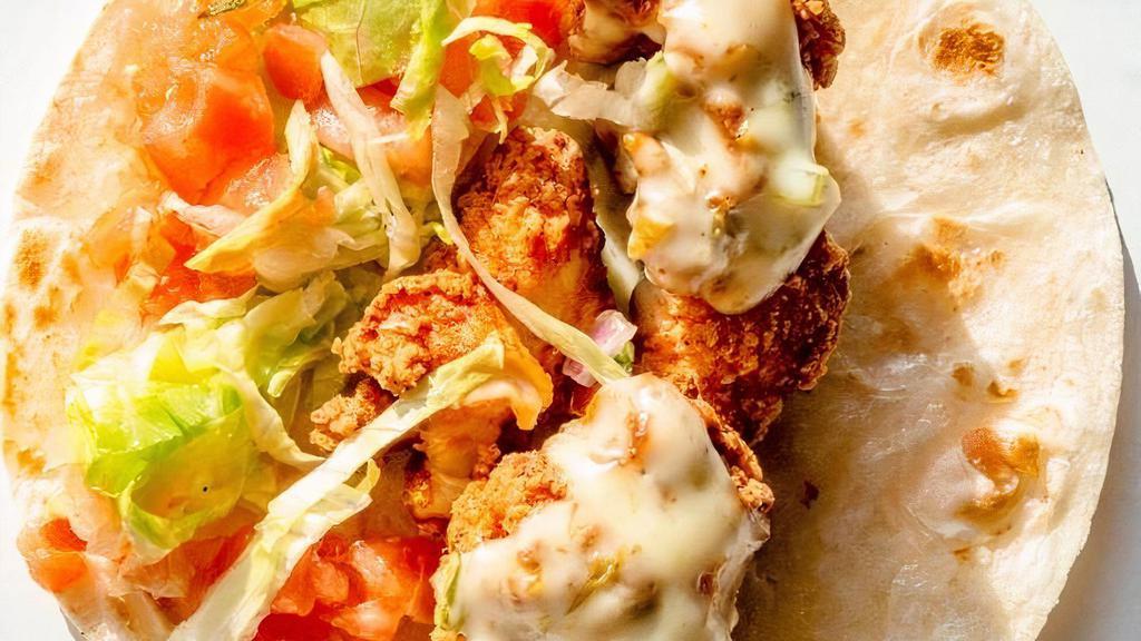 Crispy Chicken · Marinated chicken lightly breaded and fried to golden brown. Served over lettuce and topped with queso and tomatoes.