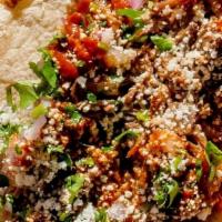 Barbacoa Taco · Slow roasted brisket in red chili sauce. Topped with roasted chili salsa, cilantro, red onio...